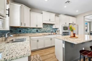 Colorful blue backsplash in a white kitchen