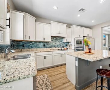 Colorful blue backsplash in a white kitchen