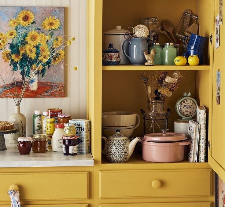 Yellow cabinets full of colorful items are a way to achieve one of this year's most popular kitchen design trends. 