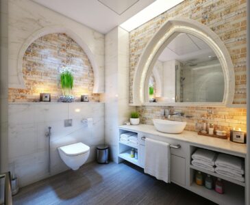 white bathroom with stone wall and arched mirrors