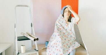 stressed woman covered with wallpaper