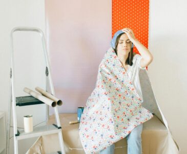 stressed woman covered with wallpaper