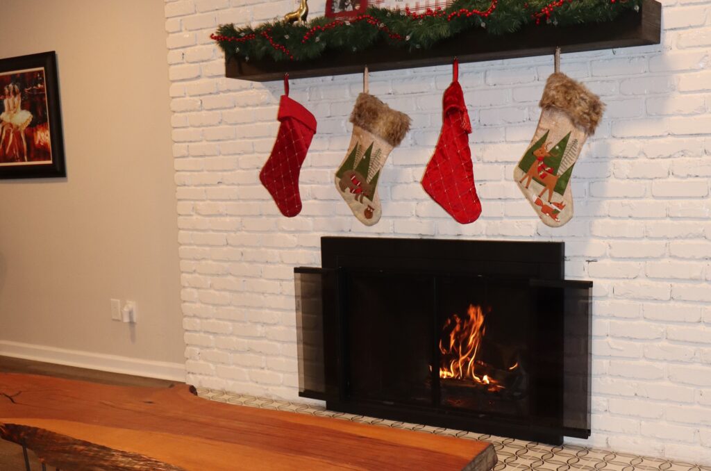 White brick fireplace with Christmas decorations