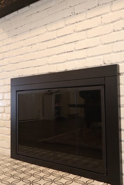 Black fireplace cabinet with glass doors